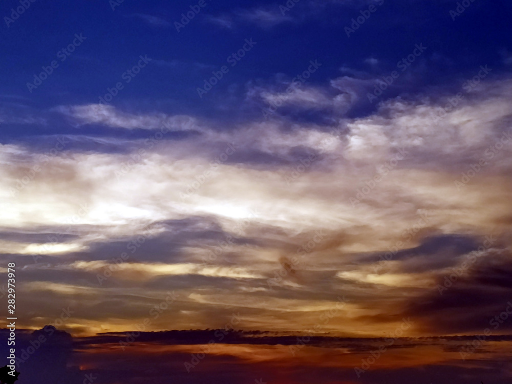 multi colored clouds in the evening sky multi colored clouds in the evening sky
