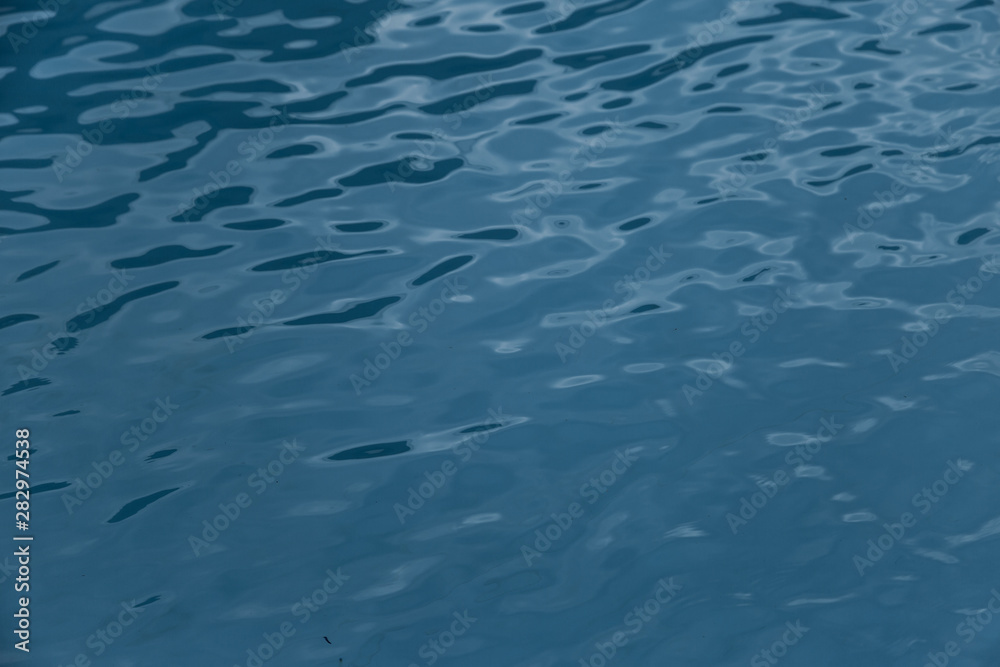 Blue swimming pool edge with refection of water ripple Blue swimming pool edge with refection of water ripple