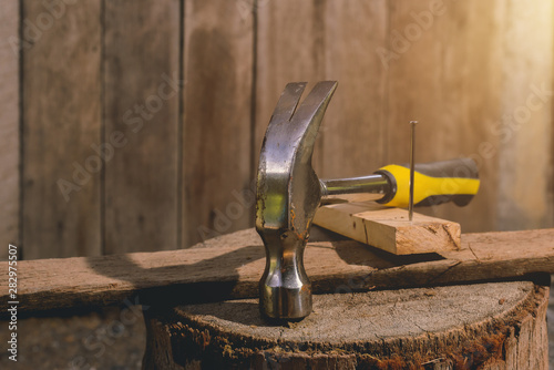 Hammer and nails on wooden plates