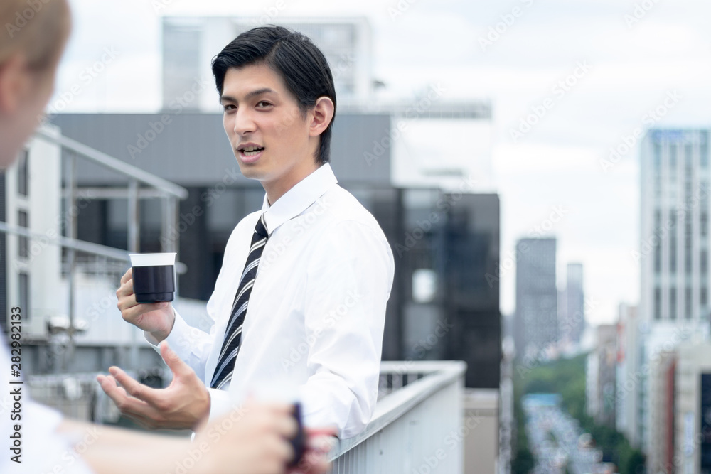 屋上で休憩を取るビジネスマン