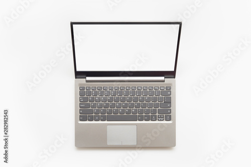 Top view of Open modern laptop with English keyboard and copy space blank screen, isolated on white background. photo