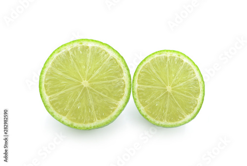 Half of lime citrus fruit (lime cut) isolated on white background.