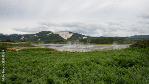 Panorama of hot springs, boiling mud pools and warm toxic lakes in Uzon caldera. Kronotsky Nature Reserve in Russian far east, Kamchatka peninsula. Protected environment . Access by helicopter only. photo