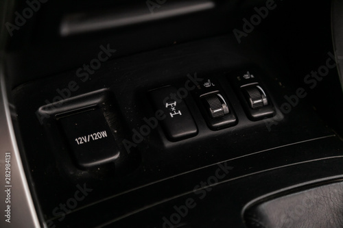 Close-up of seat heating, charging in the car, off road  suspension control buttons. modern car interior: parts, buttons, knobs. © Виталий Сова