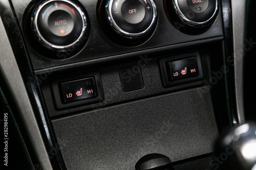 Close-up of seat heating buttons. modern car interior: parts, buttons, knobs.
