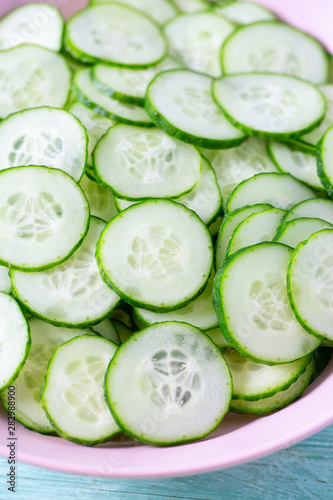 cucumbers in a bowl on turquoise surface