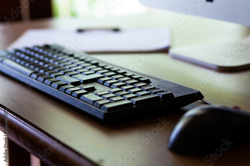 Photo of a computer keyboard with selective focus on the keys and a soft