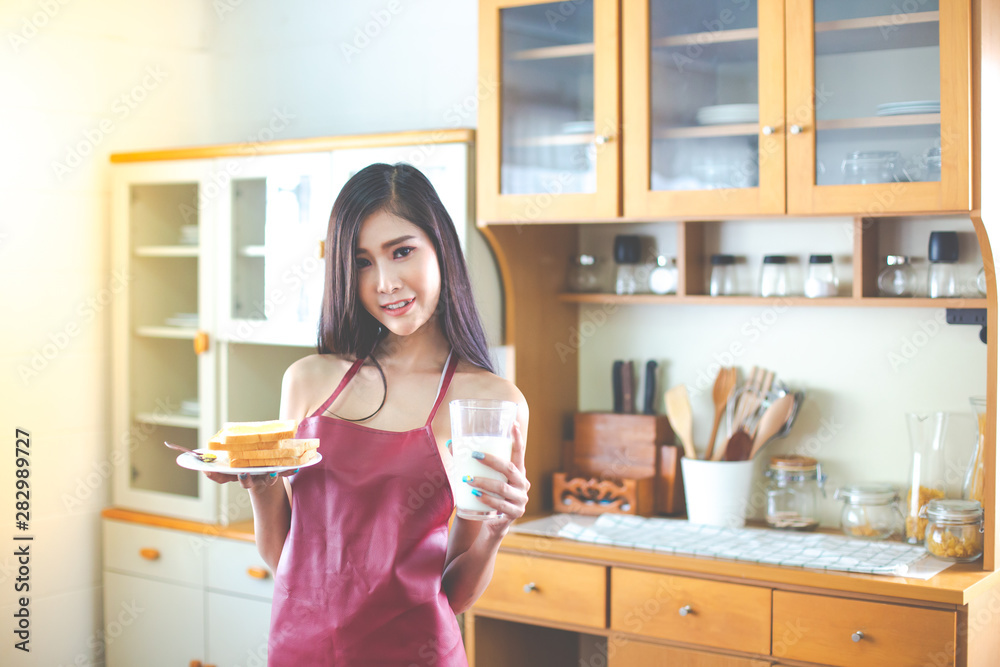 sexy Woman in lingerie drinking a glass of milk in kitchen sexy Woman in lingerie drinking a glass of milk in kitchen