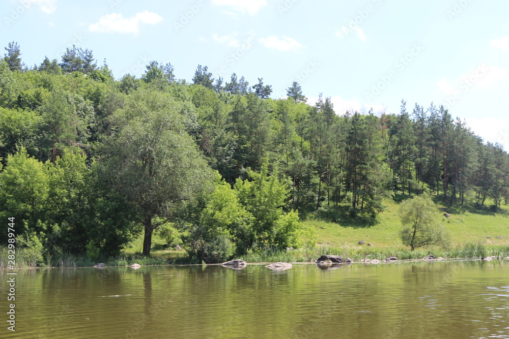 The bank of the plain river invites tired travelers to relax The bank of the plain river invites tired travelers to relax