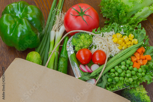 Healthy food in full paper bag of different products, vegetables. Top view. Food background.