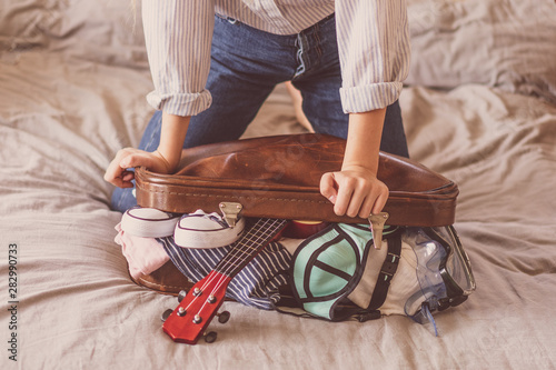 Female Packing Suitcase And Getting Ready For Traveling. Travel suitcase prepareing concept