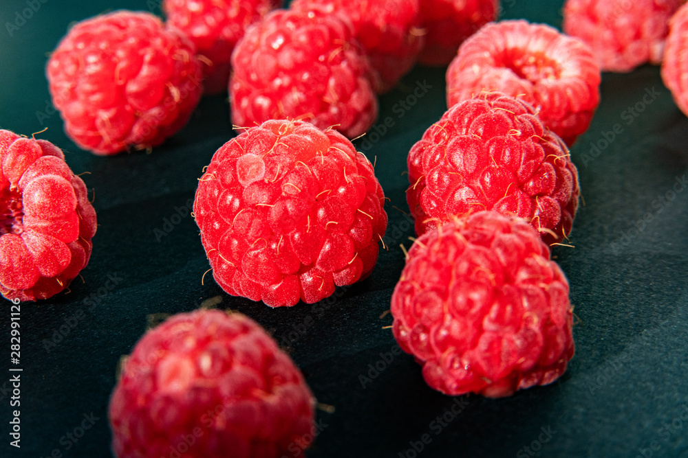 Fresh organic raspberries background closeup. Fresh raspberries on black background Fresh organic raspberries background closeup. Fresh raspberries on black background