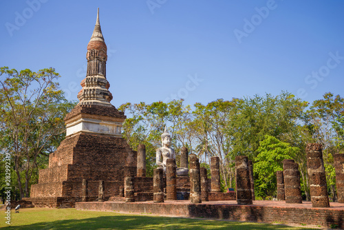 Sculpture of a sitting Buddha on the ruins of an ancient Buddhist temple  Sukhothai. Thailand