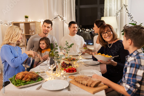 celebration, holidays and people concept - happy family having dinner party at home