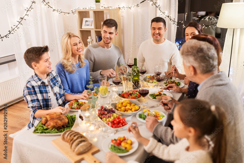 celebration, holidays and people concept - happy family having dinner party at home celebration, holidays and people concept - happy family having dinner party at home