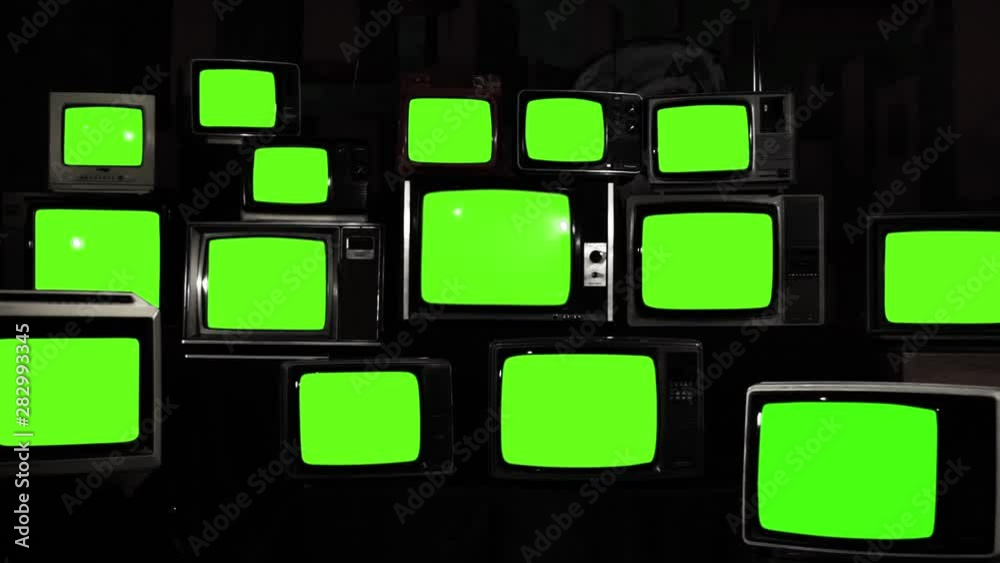 Stacked Vintage TVs Turning On Green Screens. You can replace green