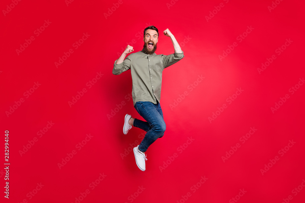 Full length body photo of crazy guy enjoying his promotion at work while isolated with red background Full length body photo of crazy guy enjoying his promotion at work while isolated with red background