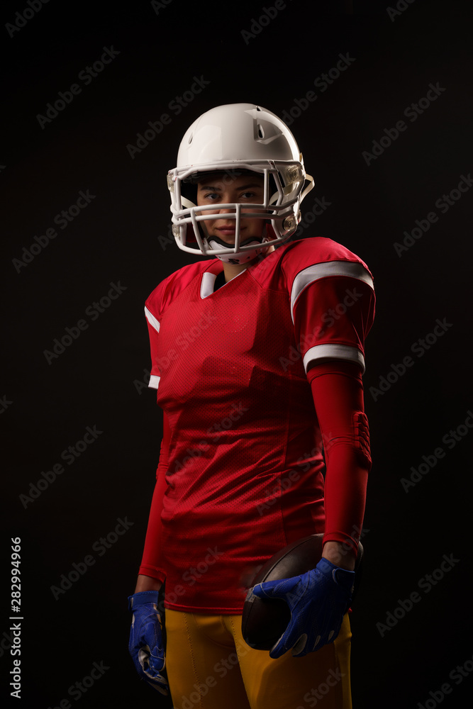 Image of rugby player woman looking into camera on empty black background