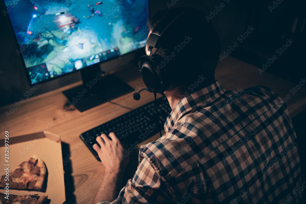 Close up back rear behind view photo he him his guy videogame headset microphone teammates shooter role attentively look watch observe screen action wear casual plaid checkered shirt table indoors Close up back rear behind view photo he him his guy videogame headset microphone teammates shooter role attentively look watch observe screen action wear casual plaid checkered shirt table indoors