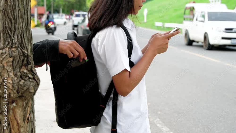 Woman on park street is unaware that her purse has been stolen by ...