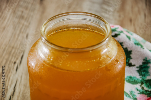 sweet honey in a jar on a wooden background