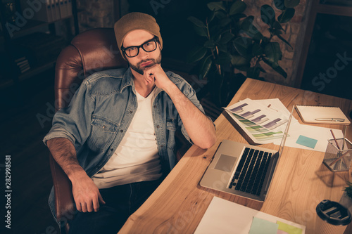 Photo of thoughtful interesting wise and intelligent financial analytic weraing brown hat cap being to analyze his company abilities in contesting with other similar companies