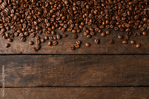 Coffee beans on wooden background with copyspace. photo