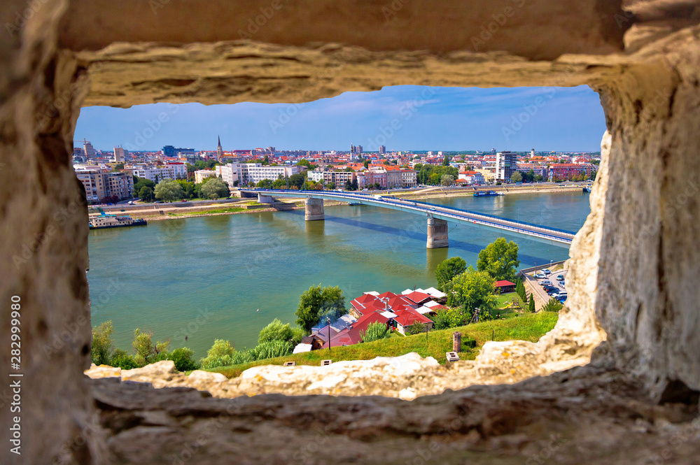 Wall Mural City Of Novi Sad and Danube river aerial view through stone window from Petrovar
