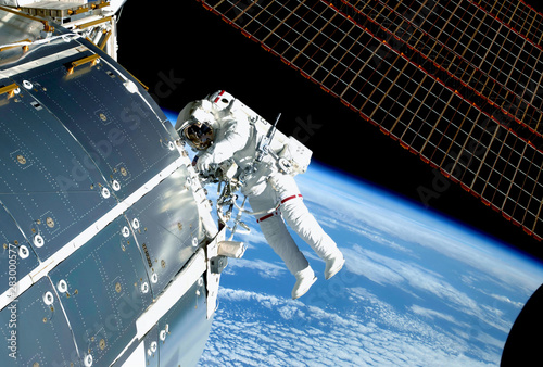 The astronaut in an outer space, at the ISS, repairs and makes experiments. Elements of this image were furnished by NASA photo