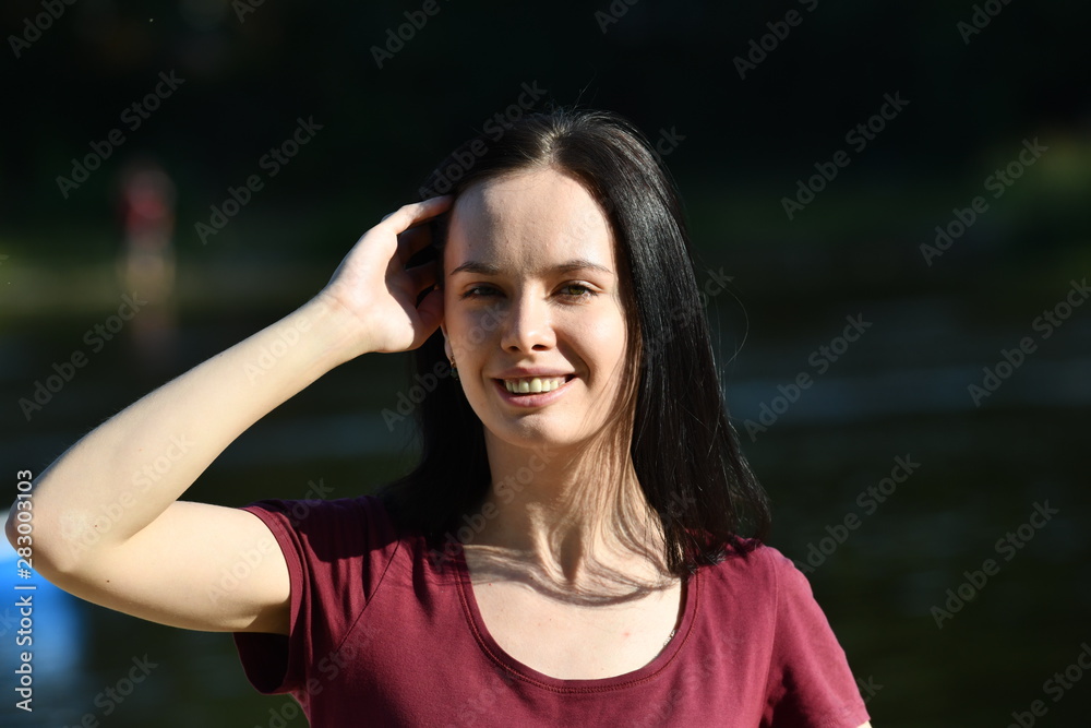 portrait of young woman against blurred river bacground
