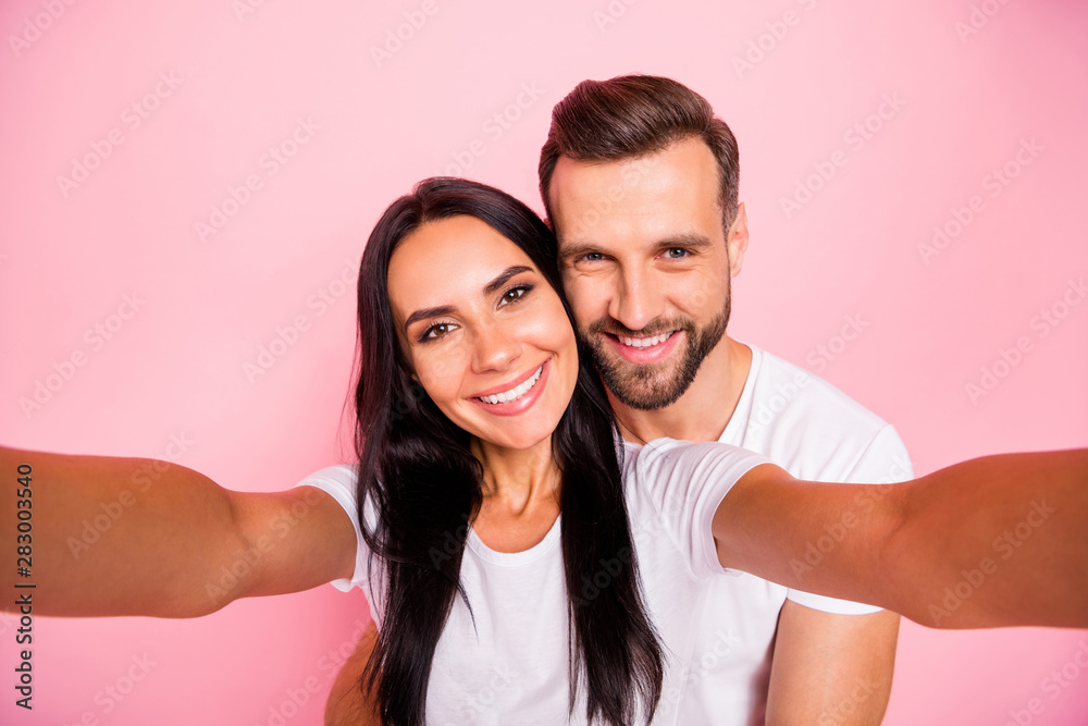 Photo of nice couple with man hugging his beloved girlfriend from back while isolated with pastel background