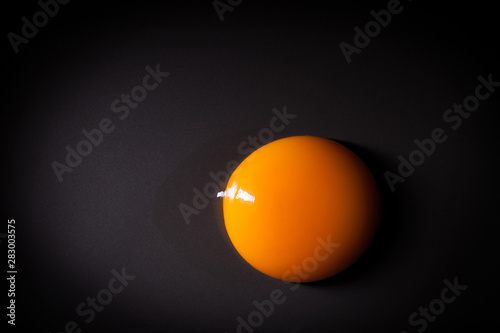 Egg yolk isolated on black background with space for copy