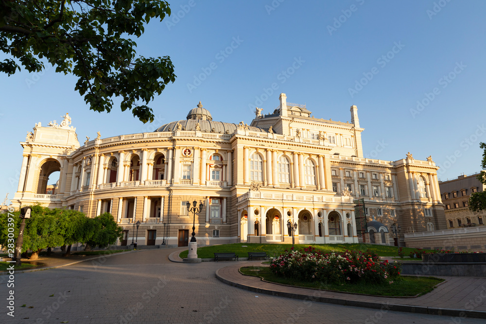 Ukraine, Odessa, 13th of June 2019. Side view of the national academic opera building and the park with beautiful flower beds during a sunny day