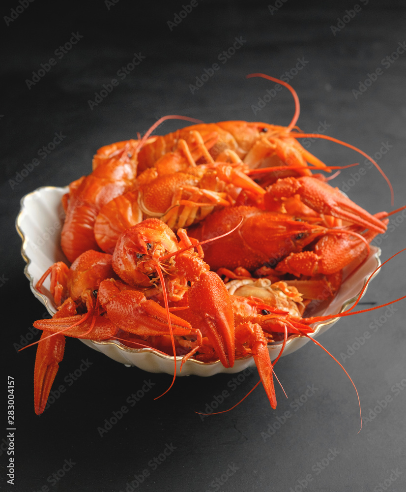 lobsters in a plate on black background lobsters in a plate on black background