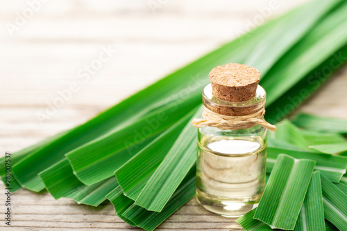 lemongrass essential oil in the glass bottle  with fresh lemongrass  on the wooden board