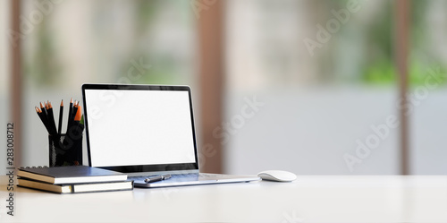 Minimal comfortable work place with blank screen laptop
