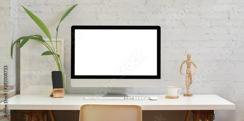 Contemporary workplace with blank screen desktop photo