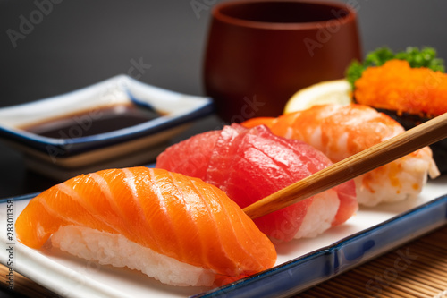 Sushi salmon & tuna sushi shrimp and wasabi on the white plate isolated.selective focus