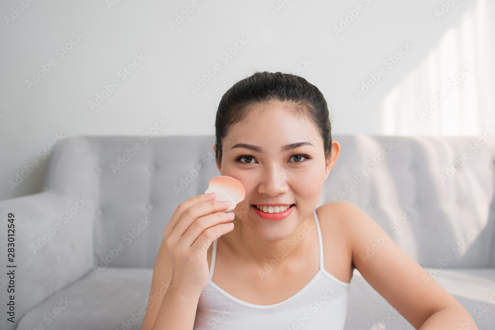 Beautiful Asian girl with cosmetic powder brush for make up. Make-up concept Beautiful Asian girl with cosmetic powder brush for make up. Make-up concept