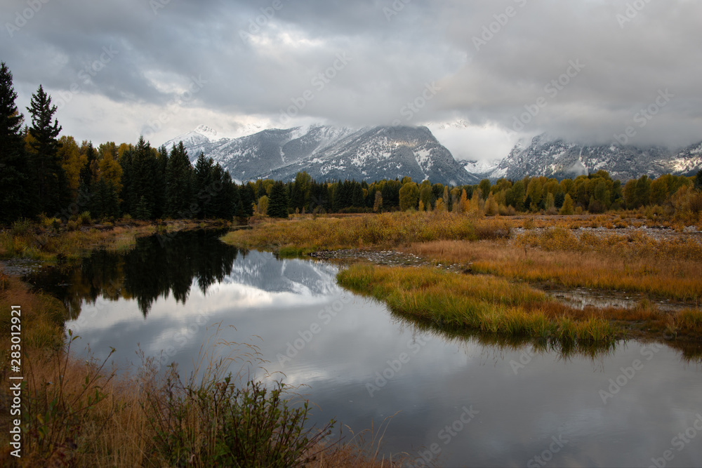 Fototapeta premium Teton Range covered in clouds in autumn, Grand Teton National Park