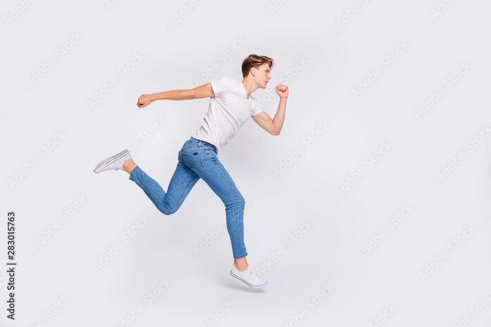Full length photo of jumping high guy ready steady go concept wear casual outfit isolated white background Full length photo of jumping high guy ready steady go concept wear casual outfit isolated white background