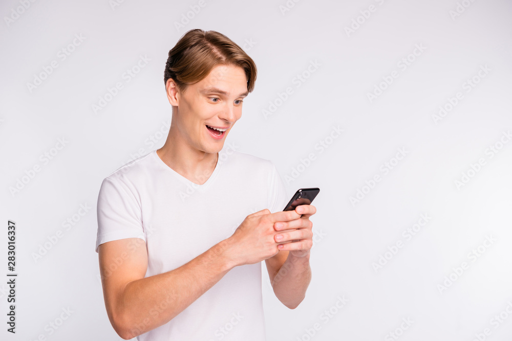 Photo of amazing guy holding telephone hands wear casual outfit isolated on white background Photo of amazing guy holding telephone hands wear casual outfit isolated on white background