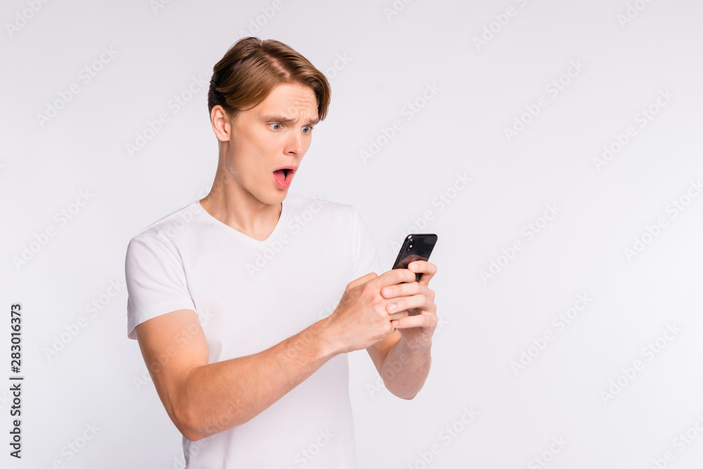Photo of amazing guy holding telephone hands wear casual outfit isolated on white background Photo of amazing guy holding telephone hands wear casual outfit isolated on white background