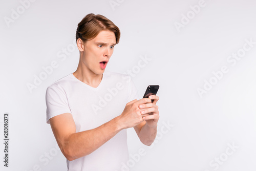 Photo of amazing guy holding telephone hands wear casual outfit isolated on white background © deagreez
