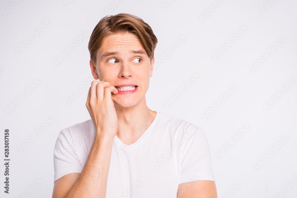 Teen guy looking side empty space with eyes full of fear wearing casual outfit isolated on white background Teen guy looking side empty space with eyes full of fear wearing casual outfit isolated on white background