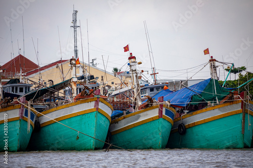 Traditional Vietnamese fishing boats in a harbor near Mỹ Tho in the Mekong Delta