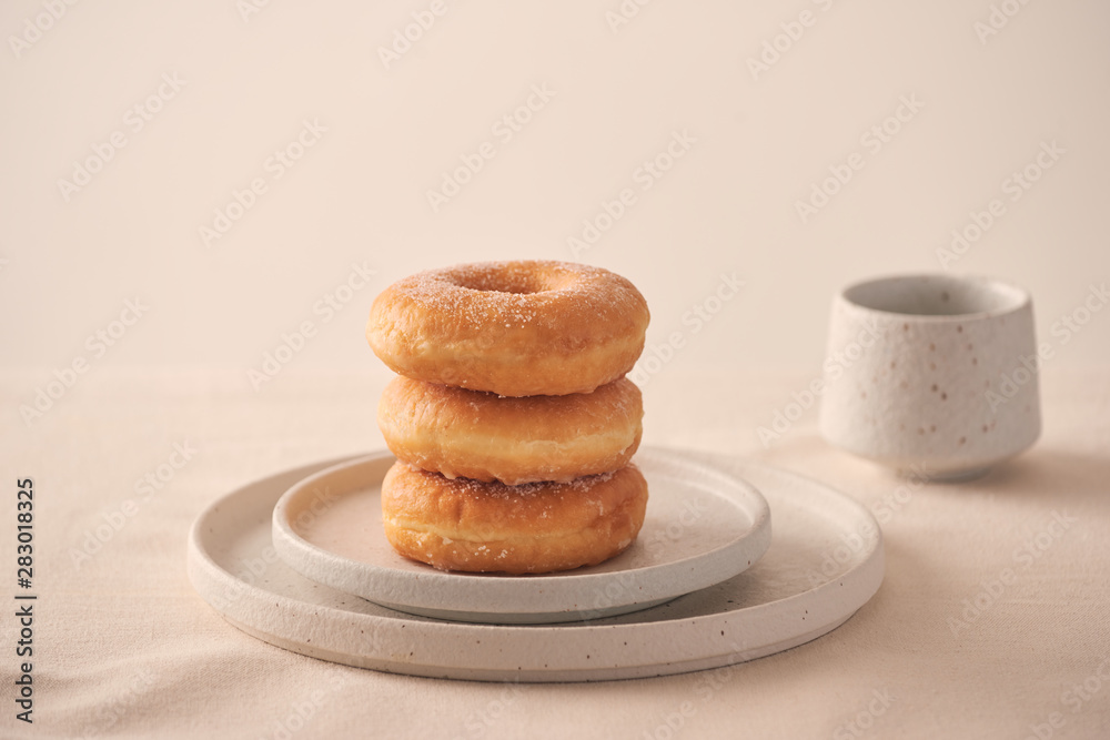 Stack of homemade baked donuts sitting on white plate