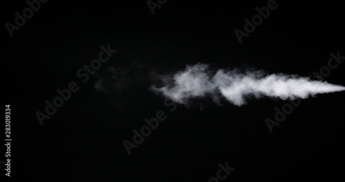 White smoke trail isolated on black background. © mputsylo