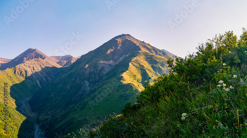 Panorama of a mountain valley in summer  aerial view. Fairytale sunset over the mountain peaks  amazing nature  summer in the mountains. Travel  tourism. beautiful background picture of nature