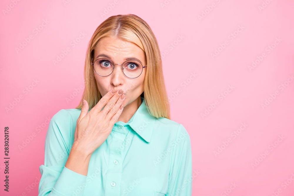 Close up photo of anxious person closing her mouth look wearing mint color shirt isolated over pink background